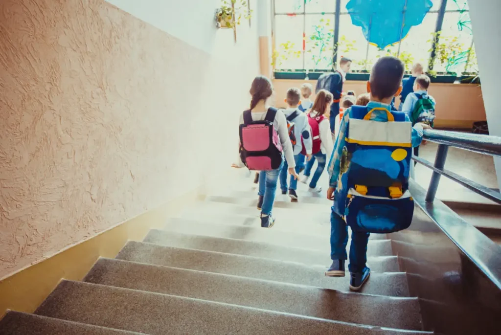 Students walking down stairs at school. Contact Schendel Pest Services to protect your daycare center or school from unwanted pests.