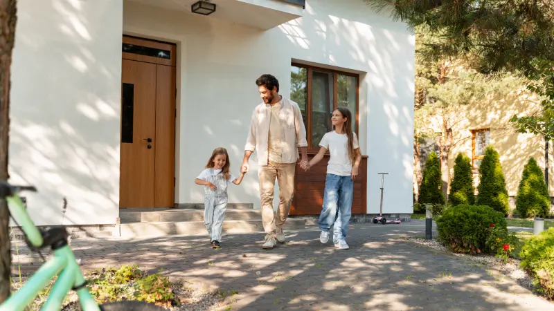 Father with children on the front porch of a home